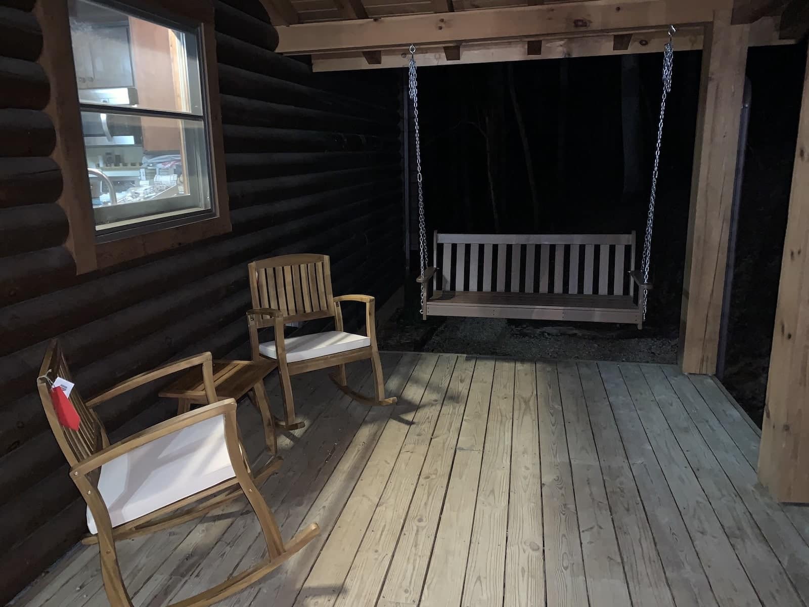 Exterior of deck Nessi Homes corporate event cabin during sunset in Western North Carolina.